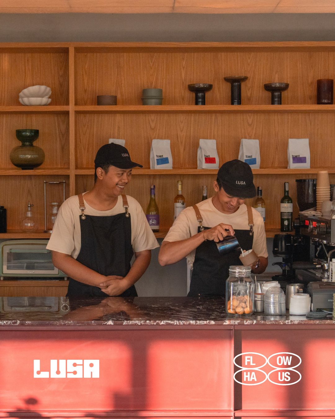 Two baristas working behind the counter at LUSA Bistro